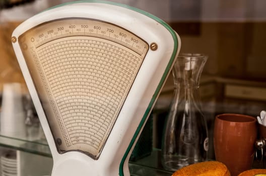 Old white vintage scale on store, Portugal