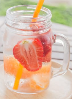 Infused water mug of mix fruit refreshing drink, stock photo
