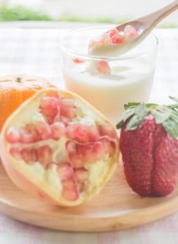 Glass of yogurt with fresh mix fruit , stock photo