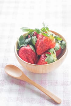 Fresh strawberry on wooden bowl, stock photo