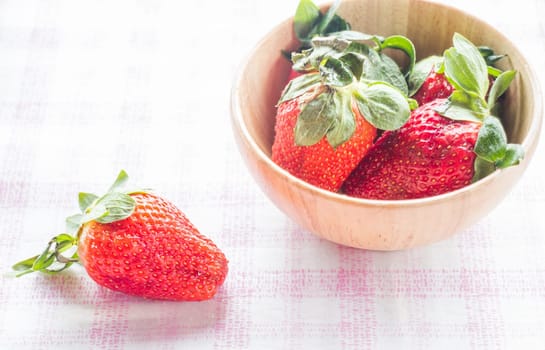 Fresh strawberry on wooden bowl, stock photo