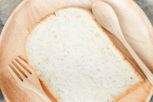 Sliced of whole wheat bread on wooden plate, stock photo