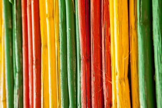 Painted bamboo canes with reggae colors. Background
