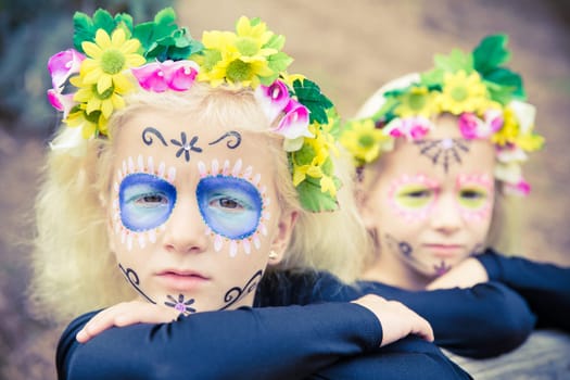 Little girls with black clothing and sugar skull makeup