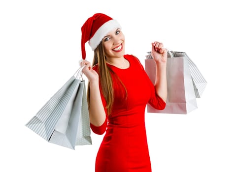 Beautiful and attractive woman with a santa hat holding shopping bags