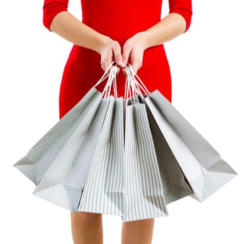Beautiful and attractive woman with a sexy dress holding shopping bags