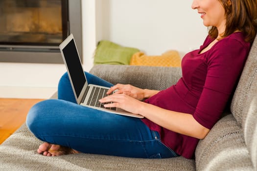 Beautiful woman sitting on the floor working with a tablet