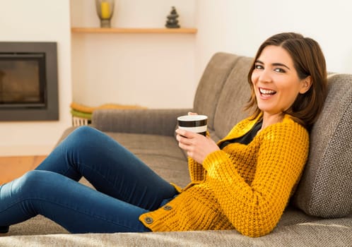 Beautiful woman at home Having a good time with cup a coffee