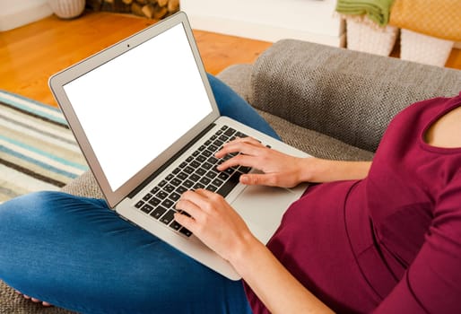 Beautiful woman sitting on the floor working with a tablet