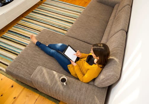 Shot of a gorgeous young woman using a digital tablet indoors, with copy space