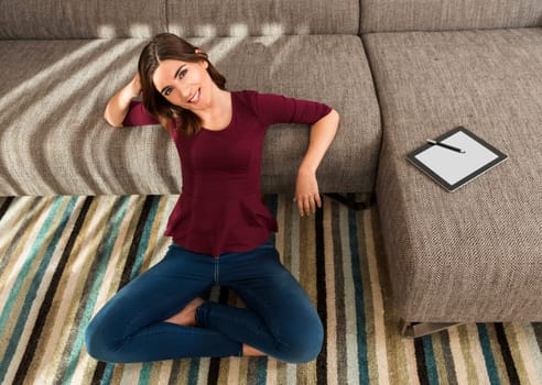 Gorgeous woman at home working with a tablet