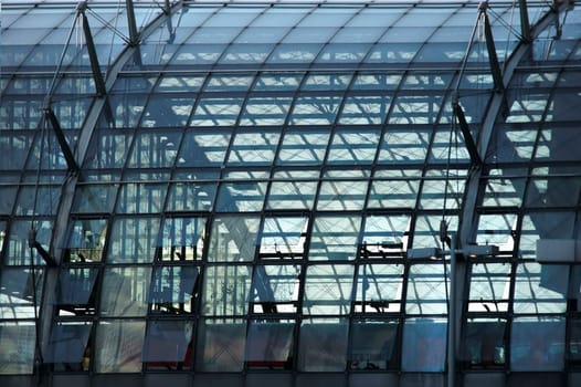 A round glass dome roof on one side of Berlin's main train station.