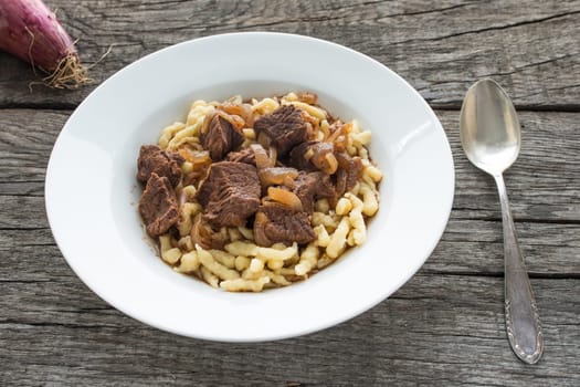 Plate with goulash of beef with Spätzle