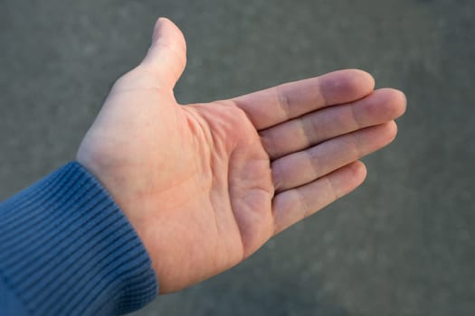 Open hand against grey fuzzy background