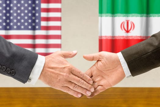 Representatives of the United States and Iran shake hands