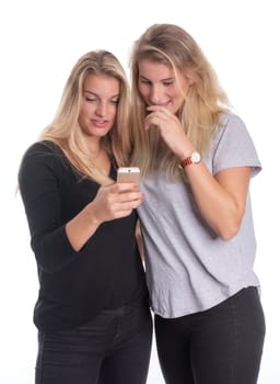 Two blonde girlfriends look at a mobile phone message together