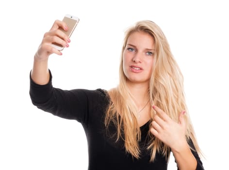 Blonde girl takes a selfie and looks skeptical