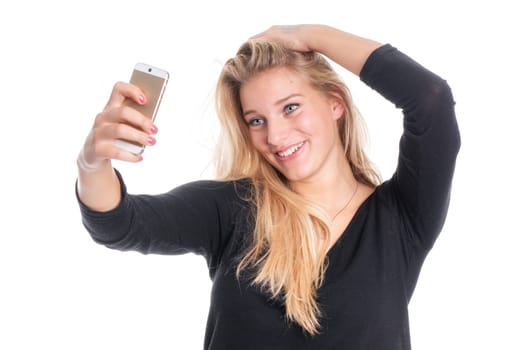 Pretty blonde takes a selfie with her phone and smiles