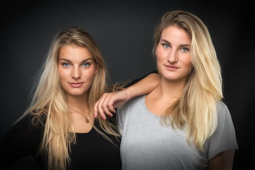 2 attractive blonde young girls in portrait