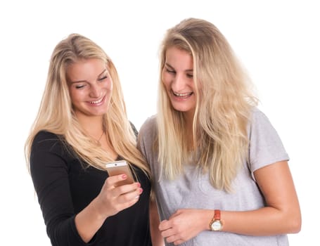 Two blonde girlfriends look at a mobile phone message together
