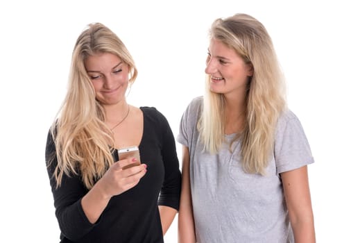Two blonde girlfriends look at a mobile phone message together