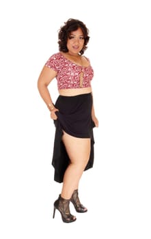 A mixed raced young woman standing isolated for white background.in a black skirt, showing her legs..