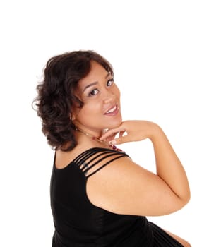 A beautiful young mixed raced woman in a black dress with her hand under.her chin, isolated for white background..