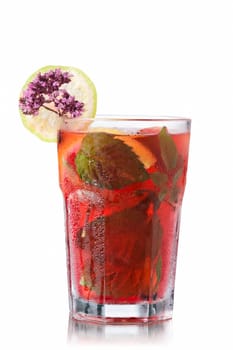 Strawberry mojito garnished with lime slice and marjoram (wild oregano)