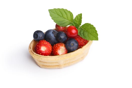 Dessert with wild berries.  Sweet tart with wild strawberry, blueberry and foxberry. Large depth of field