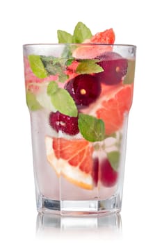 Grapefruit cherry mojito cocktail in faceted highball. Refreshing summer drink with rum,grapefruit and fresh mint