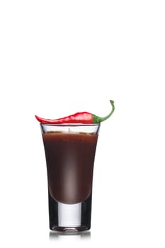 Dessert with chocolate decorated with red hot chilli pepper in a shot glass. Sweet food. Parfait