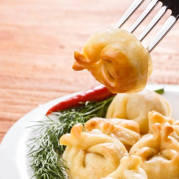 Fried dumplings. Russian pelmeni  with meat on a plate. Hearty and tasty  dinner.