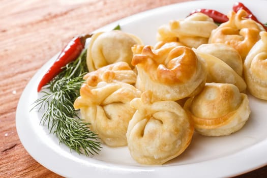 Fried dumplings. Russian pelmeni with meat on a plate. Hearty and tasty  dinner.