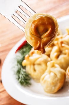Fried dumplings. Russian pelmeni with meat on a plate. Hearty and tasty  dinner.