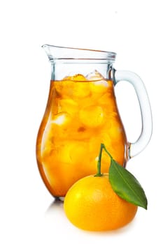 Tangerine lemonade with ice in a pitcher. Jug full of iced tangerine drink.