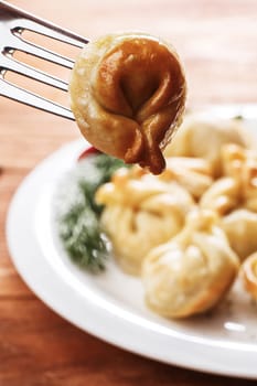 Fried dumplings. Russian pelmeni with meat on a plate. Hearty and tasty  dinner.