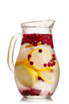 Cranberry lemon detox water in a glass jug. Healthy water with infused cranberry, cowberry and lemon