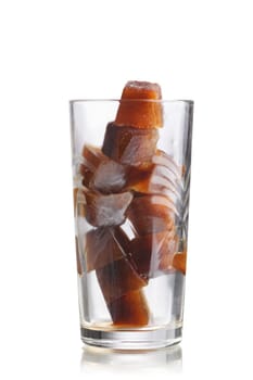 Frozen coffee cubes into highball glass. Preparations for iced coffee cocktail