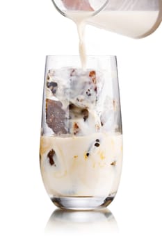 Milk coffee cocktail from frozen coffee cubes in highball glass. Iced milk coffee