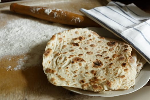 Traditional lavash (homemade armenian bread) on wooden table.