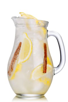 Jug of lemon cinnamon sparkling lemonade (spritzer). Carbonated iced water with lemon and cinnamon sticks in a glass pitcher