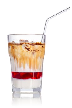 Layered iced milkshake with strawberry syrup, condensed milk and chocolate. Delicious milk cocktail in highball glass with straw