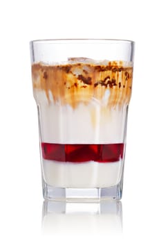 Layered iced milkshake with strawberry syrup, condensed milk and chocolate. Delicious milk cocktail in highball glass