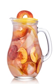 Pitcher of carbonated peach lemonade garnished with peach wheel and lemon slice. Jug full of cold peach spritzer with peach and lemon slices.