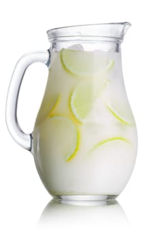 Jug of Brazilian lemonade (limeade) decorated with lime slices.