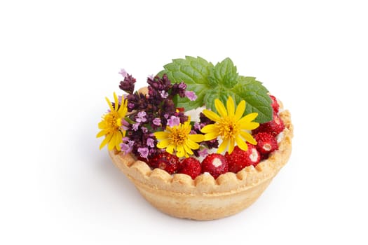 Dessert with wild berries decorated with mint leaves and wildflowers. Sweet tart with wild strawberry, blueberry and red currant. Large DOF