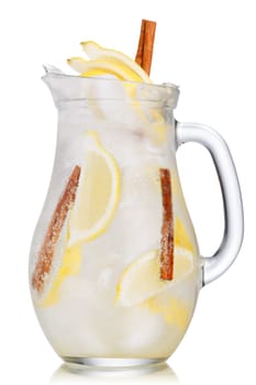 Jug of lemon cinnamon sparkling lemonade (spritzer). Carbonated iced water with lemon and cinnamon sticks in a glass pitcher