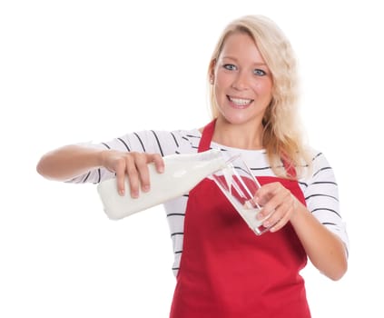 Woman in red apron pours a glass of milk