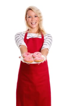 Blonde woman in apron offers plates with doughnuts