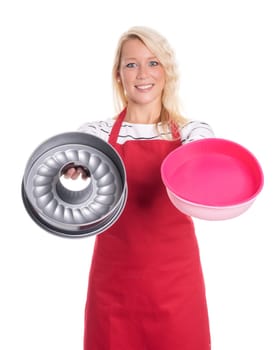 Housewife in apron keeps various baking tins